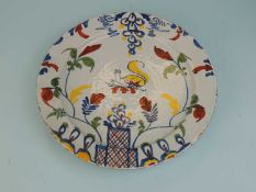 BRISTOL DELFT POLYCHROME CHARGER, 18th century, centred with a squirrel, and with a lattice tower in