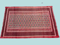 TURKISH FLAT WEAVE WOOLLEN RUG, faded red field and lattice border, late 20th century, 280 x