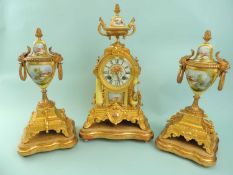 LATE 19TH CENTURY FRENCH CLOCK GARNITURE, gilt metal with porcelain mounts, on giltwood stands,