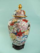 CHINESE CLOISONNÉ MILLE FLEURS LIDDED BALUSTER VASE, with gilt finial, on stained pierced hardwood