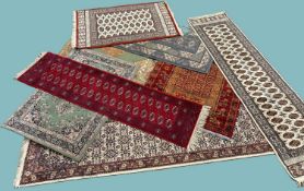 EIGHT DECORATIVE RUGS, all machine made with the exception of a fawn ground runner, all late 20th