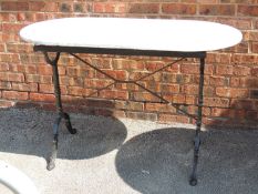 GARDEN TABLE with a marble top and cast-iron base, 78 (h) x 120 (w) x 61cms (d) Provenance: