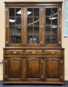 TITCHMARSH & GOODWIN OAK CUPBOARD BOOKCASE, upper section with three lattice glazed doors, base with