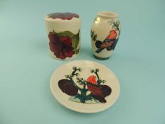 THREE MOORCROFT PIECES, 'Hibiscus' pattern lidded pot, 9.5cms (h); 'Plum Tree and Bird' pattern