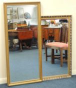 TWO MODERN GILT FRAMED WALL MIRRORS, largest 136 x 62cms, other 112 x 87cms Provenance: private