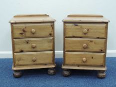 PAIR OF LACQUERED PINE BEDSIDE CHESTS, three drawers, turned knob handles, bun feet, 60 (h) x 46 (w)