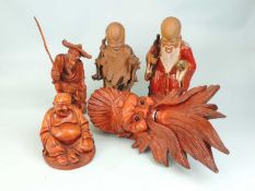 TWO CHINESE STONEWARE FIGURES OF SHOU LAO, 29cms (h); also a Chinese carved wooden mask, 36cms (