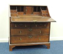 GEORGE II OAK BUREAU c. 1740-60, stepped interior with a well, 100 (h) x 91 (w) x 53cms (d)