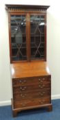 MAHOGANY BUREAU BOOKCASE of small proportions, the top with astragal glazed doors opening to