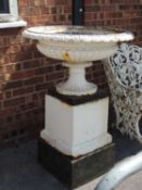 19TH CENTURY CAST-IRON SHALLOW GARDEN URN, on stepped square plinths, 110 (h) x 76cms (diam.)