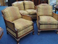 EDWARDIAN STYLE MAHOGANY BERGÈRE THREE-PIECE SUITE, post 1988, with fire labels intact, double caned