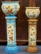 TWO BURMANTOFTS SUNFLOWER PATTERNED POTTERY JARDINIÈRES ON STANDS, 95cms (h) and 84cms (h)