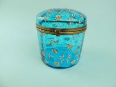 FRENCH TURQUOISE GLASS CASKET of circular form, enamelled white floral decoration, hinged cover with