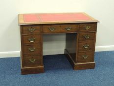 OAK TWIN-PEDESTAL DESK of small proportions, with tooled red leather top, 72 (h) x 107 (w) x