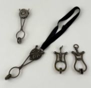 FOUR NICKEL / METAL TONG SKIRT LIFTERS, one stamped Plant & Breen 'The Times' Provenance: private