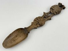WELSH WOODEN LOVE SPOON, possibly sycamore, handle pierced and with two carved floral rosettes,