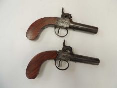 TWO 19TH CENTURY BOX LOCK PERCUSSION POCKET PISTOLS, with 6cms screw-off barrels, engraved lock