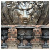 PAIR OF CAST IRON CAMPAGNA GARDEN URNS, painted black, with lion mask handles, 60 (h) x 47cms (