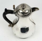 EDWARD VII GEORGIAN STYLE HOT WATER JUG of baluster form, gadrooned rim and base, ebonised wooden
