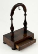 19TH CENTURY WALNUT POCKET WATCH STAND, turned arched frame, rectangular base with drawer, on bun
