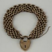 18CT ROLLED GOLD GATE BRACELET with heart-shaped locket, 18cms (l) Provenance: private collection