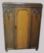 OAK CARVED SMALL WARDROBE of Gothic inspired design, 167 (h) x 124 (w) x 51cms (d) Provenance: