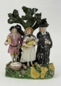 STAFFORDSHIRE PEARLWARE FIGURE GROUP, c. 1820, 'The Tithe Pig', 17cms (h) Provenance: private