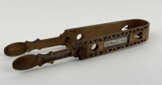 WELSH SYCAMORE LOVE TOKEN SUGAR TONGS of traditional form, late 19th century, pierced with hearts