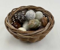 A 'CLUTCH' OF DECORATIVE EGGS, various materials including marble, onyx, and wood, contained in a