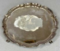 ELIZABETH II CIRCULAR SILVER SALVER, with shaped moulded border, on four scroll feet, Roberts & Dawe