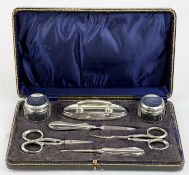 CASED SILVER MOUNTED MANICURE SET, including two glass jars, nail buffer, two pairs of scissors,