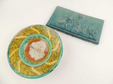 DELLA ROBBIA POTTERY BOWL, centred with masks, painted marked and conjoined initials 'AB', 23cm (d);