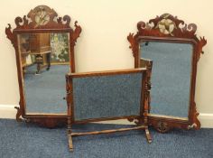 TWO WALNUT FRET WORK WALL MIRRORS, each surmounted with a Ho Ho bird, 74cms (h) and 78cms (h);