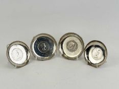PAIR OF CIRCULAR WHITE METAL PIN TRAYS, each inset with $1 coin, dated 1912 and 1930, 8cms (