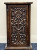 ANTIQUE OAK WALL CUPBOARD, intricately carved single door, enclosing interior with two shelves and