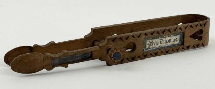 WELSH SYCAMORE LOVE TOKEN SUGAR TONGS of traditional form, late 19th century, pierced with hearts