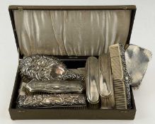 ASSORTMENT OF SILVER BACKED HAIRBRUSHES, some with embossed decoration, and a silver mounted comb