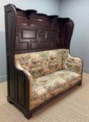 UNUSUAL ANTIQUE OAK UPHOLSTERED WINGBACK HALL SETTLE, c. 1900, later covered in printed fabric,