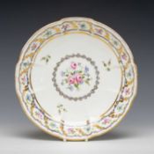 SWANSEA PORCELAIN CRUCIFORM CIRCULAR DISH, gilt line and bead rim and cavetto, enclosing Sevres