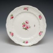 NANTGARW PORCELAIN PLATE, typical moulded border around a sequence of six open pink roses, the