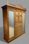 IMPRESSIVE SATIN WALNUT COMPACTUM WARDROBE, c. 1910, cornice with urn finials over dentil frieze,