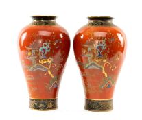 PAIR OF STAFFORDSHIRE CHINOISERIE BALUSTER VASES, enamelled with pagoda landscapes, on an orange