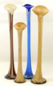 FOUR DECORATIVE COLOURED GLASS FLOOR STANDING ORCHID / STEM VASES, tallest 82cms (h), smallest 63cms