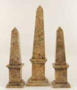 GARNITURE OF THREE POLISHED LIMESTONE OBELISKS, 48.5cms the largest, 35cms the smallest