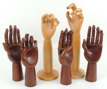 TWO DENTS ARTICULATED WOODEN GLOVE DISPLAY STANDS, 38cms (h), four further articulated hand glove