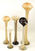 FIVE COLOURED GLASS ORCHID / STEM VASES, each with steaked brown stem, tallest 60cms (h), smallest