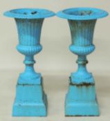 PAIR OF PAINTED CAST IRON GARDEN PEDESTAL URNS, with egg and dart collar, stepped square plinths, 82