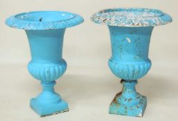 MATCHED PAIR PAINTED CAST IRON GARDEN URNS, each with egg and dart border over square base, 63cms (