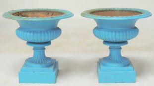 PAIR OF CAST IRON GARDEN URNS, shallow form, 45 (h) x 44cms (diam.) Provenance: The collection of