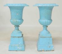 PAIR OF PAINTED CAST IRON GARDEN PEDESTAL URNS, with egg and dart collar, tapered stepped square